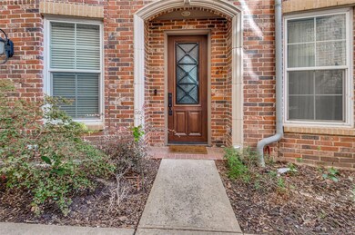 Doorway to property with brick siding