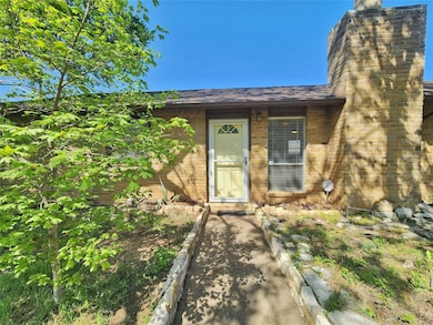 Entrance to property with brick siding, a shingle