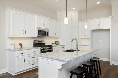 Modern white kitchen features under cabinet lights
