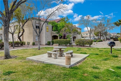View of property's community with a lawn