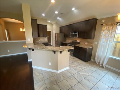 Granite countertops and custom tiled backsplash.