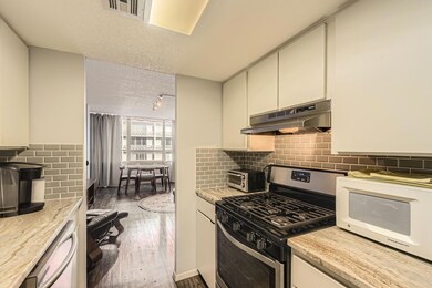 Kitchen featuring white appliances, under cabinet