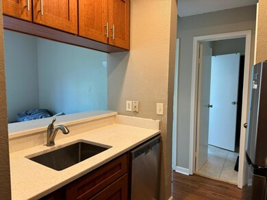 Kitchen with stainless steel appliances, dark woo