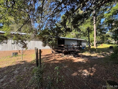 Rear of home with wood deck and shade trees