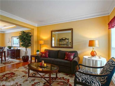 Living Room. The living and dining rooms are open to one another with lots of natural light. Hardwood floors and crown molding flow throughout the public areas of the home.