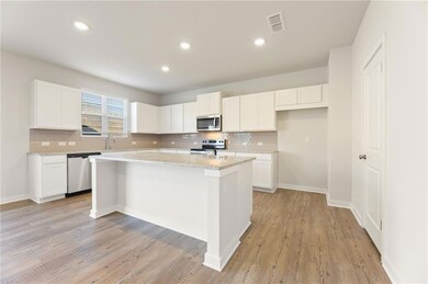 Kitchen with decorative backsplash, stainless stee