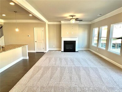 Unfurnished living room featuring crown molding an