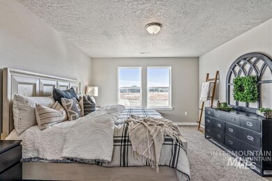 Bedroom with carpet and a textured ceiling