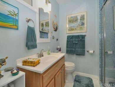 Updated bathroom with sparkling blue tile shower.