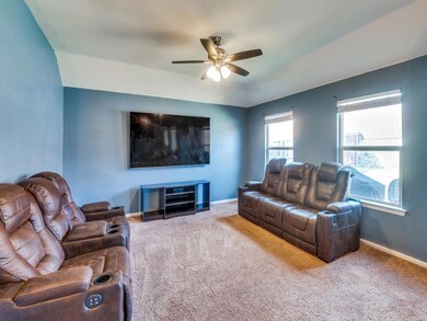 Living room with carpet floors and ceiling fan