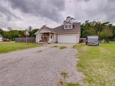 View of front of home with a garage and a front ya