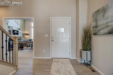 Entrance foyer featuring light wood finished floors and stairs
