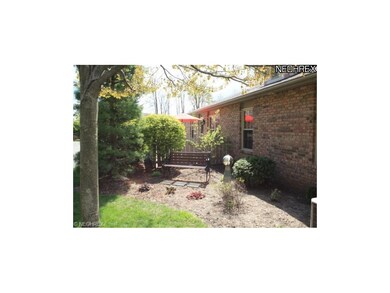 Sit on the park bench and enjoy the wooded view ac
