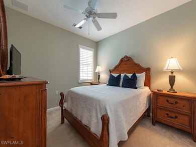 Carpeted bedroom with ceiling fan
