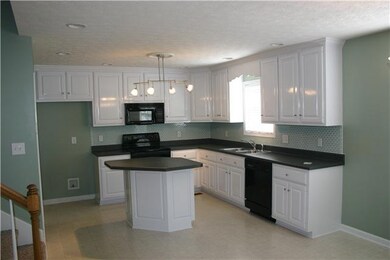 Large eat-in Kitchen with beautiful easy to clean glass backsplash lots of light bright and airy.  Center island is perfect for preparing those home cooked meals