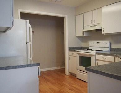Kitchen featuring white appliances, under cabinet