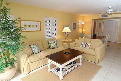 Living area with light tile patterned floors and ceiling fan