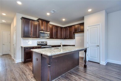 Kitchen featuring tasteful backsplash, dark hardwo