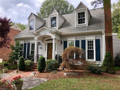 Vinyl and brick exterior, arched doorway and professional landscaping offer nice curb appeal!
