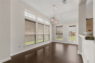 Unfurnished dining area with a chandelier, dark wo