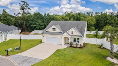 Craftsman-style home with roof with shingles, concrete driveway, a garage, a porch, and a fenced backyard