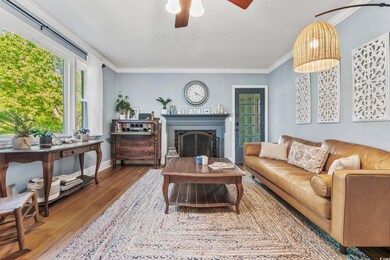 Living room with ornamental molding, hardwood / wo