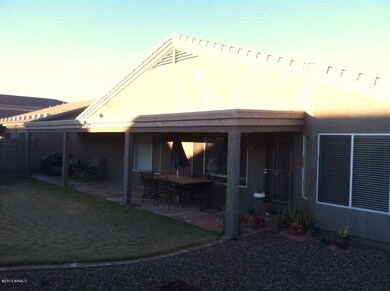 REAR OF SUBJECT AND COVERED PATIO