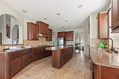Island kitchen with granite countertops, stainless