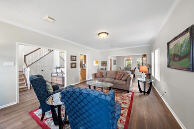The open flow from the living room to the dining a