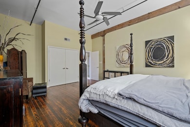 Bedroom featuring ceiling fan and dark hardwood / 