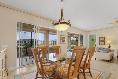 Dining area featuring a ceiling fan, light tile patterned flooring, and ornamental molding