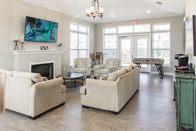 Green Wood Community Room with seating area, kitchenette, and foosball table