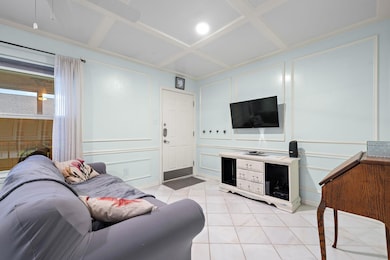 Living area with a decorative wall, coffered ceil