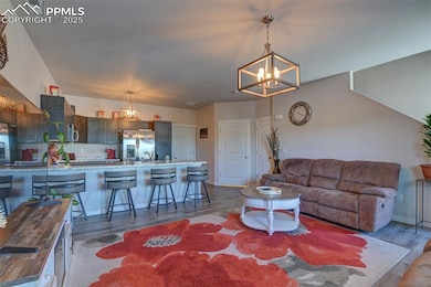 Living area featuring a chandelier and wood finished floors