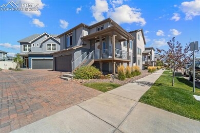 View of front of property with a balcony, a garage