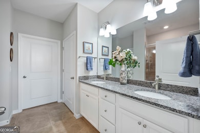 Double vanity, granite counters, large tiled shower and walk in closet