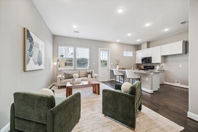 Expansive kitchen and living area with custom shelving, recessed lighting, and access to the backyard—perfect for entertaining.