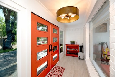 Entrance foyer featuring crown molding and a chandelier