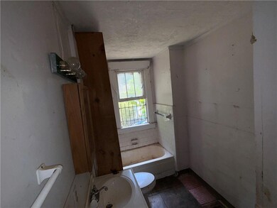 Full bathroom featuring a textured ceiling, a tub, and ornamental molding