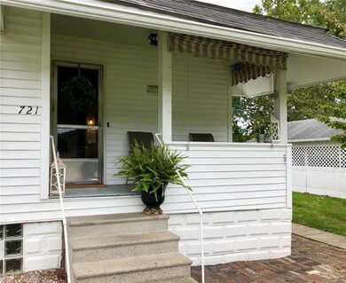 Cute covered porch with roll down awnings and exte