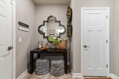 This open-concept floor plan includes the owner's entry including an entry closet and the ideal space for a bench, lockers and coat hooks for all of your seasonal gear.  Photo is of a previously built home, colors and finishes may vary.