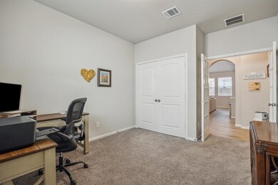 This photo showcases a cozy home office with carpe