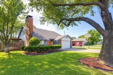 Another view of the front elevation of the home. Notice the mature shade tree in the front, as well as the well manicured landscaping. This home is move-in ready and offers a flexible floorplan.
