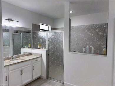 Full bathroom with vanity and a stall shower