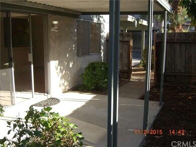 Covered Patio off Living Room with gate to rear of
