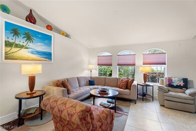Tiled living room featuring vaulted ceiling