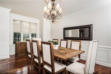 Formal Dining Room with hardwood floor, wainscot a
