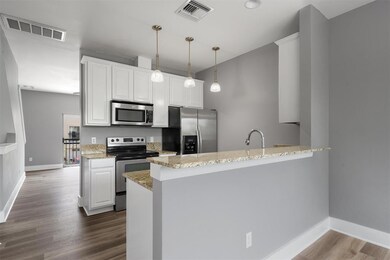 Kitchen with stainless steel appliances, a penins