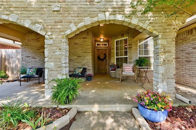 View of front facade with a front yard, driveway, brick siding, and a garage