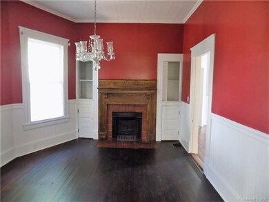 Dining room with glass chandelier. Wainscoting thr